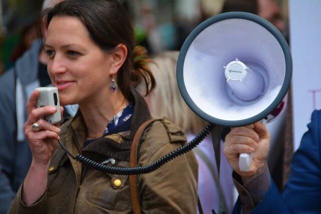 A woman speaking into a megaphone